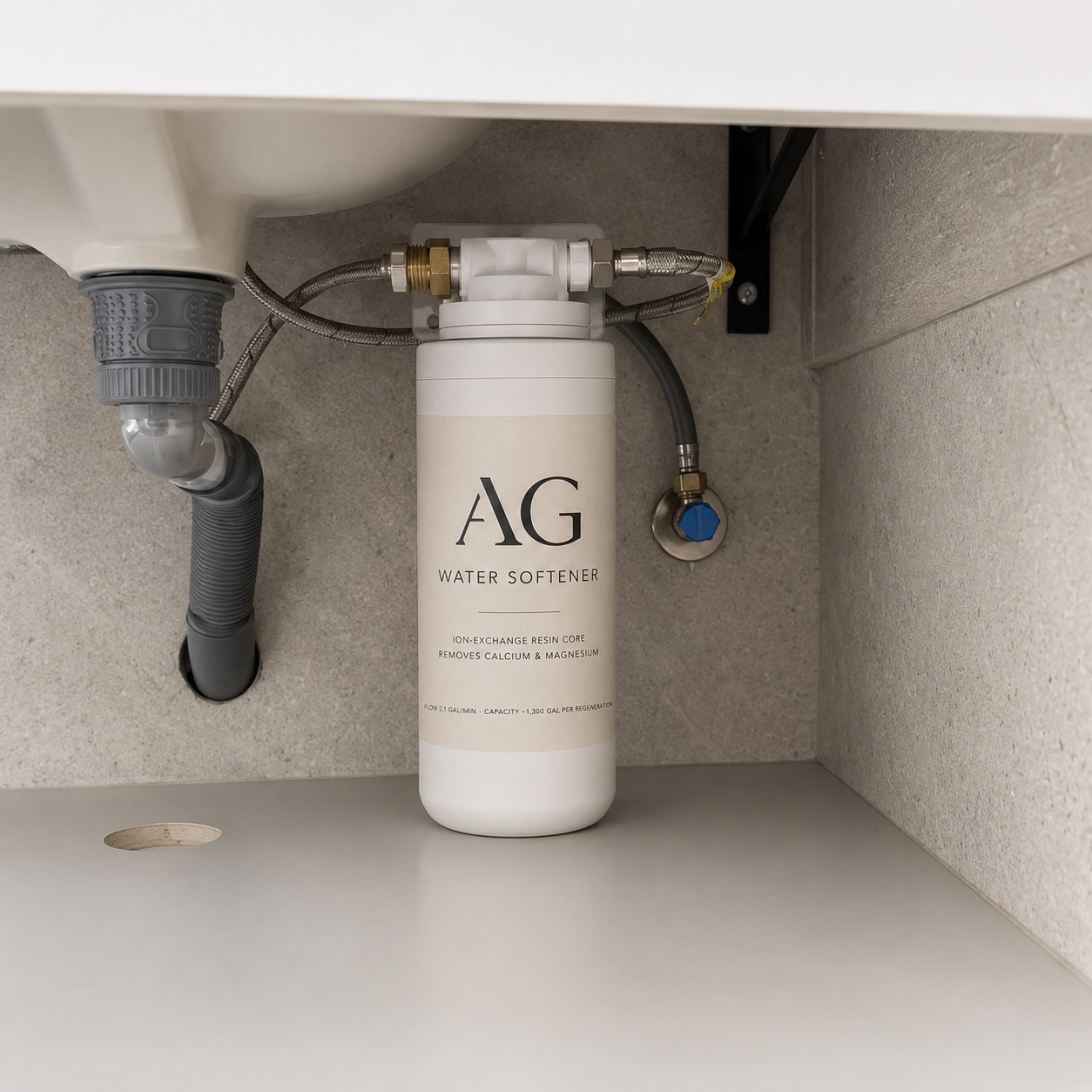 AG Water Softener installed under a sink, connected to supply lines.